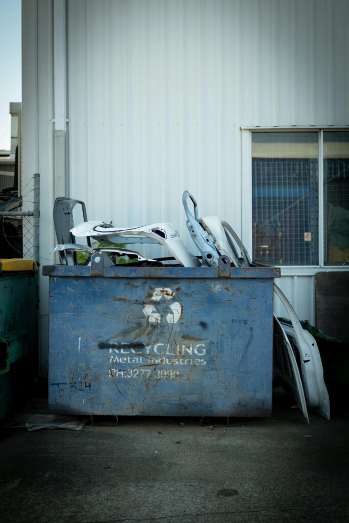 A metal recycling bin with car parts outside a building in Brisbane, Australia.